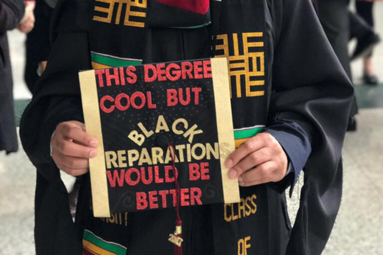 Logo for Critical University Studies (AY 22-23 CRG Research Working Group) Graduate holding cap that says "This Degree is Cool but Black Reparation would be Better"