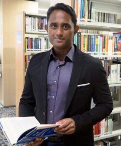 Mohamed Nawab Osman holding book