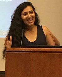Fatima speaking at a podium